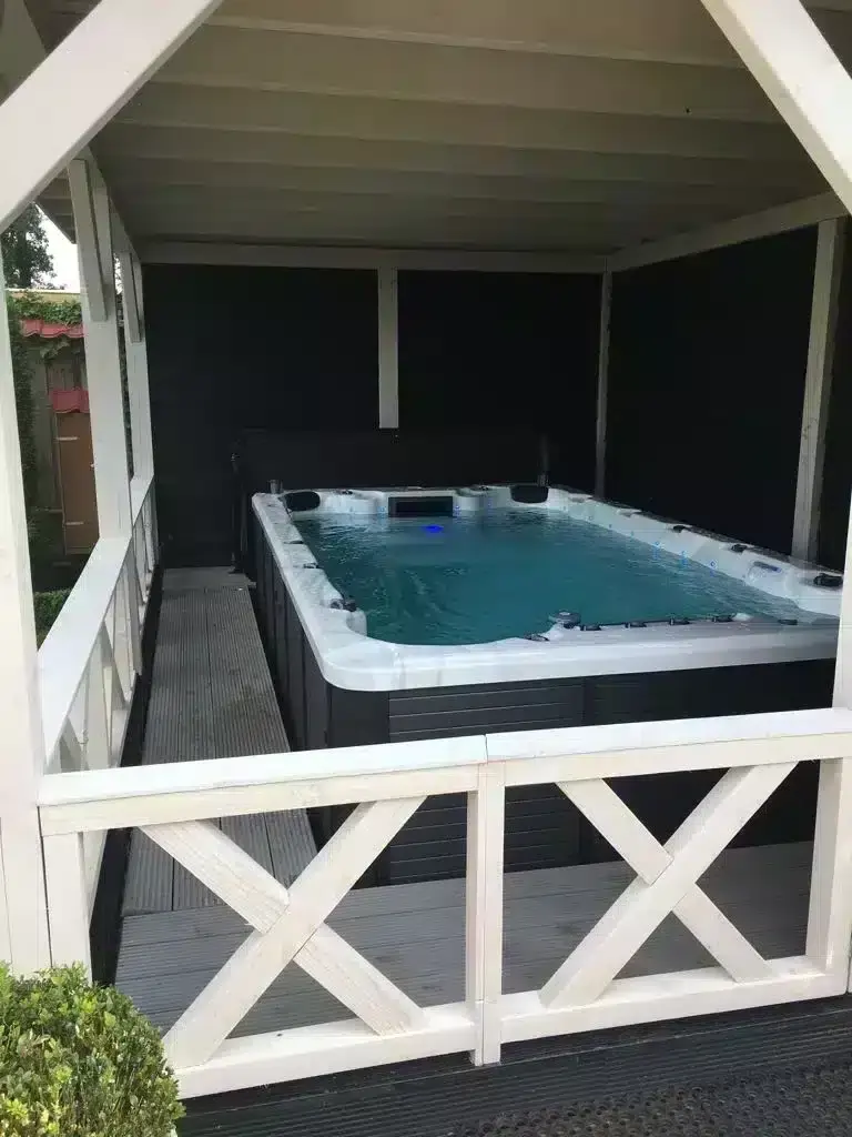 Swim spa on a garden terrace at dusk